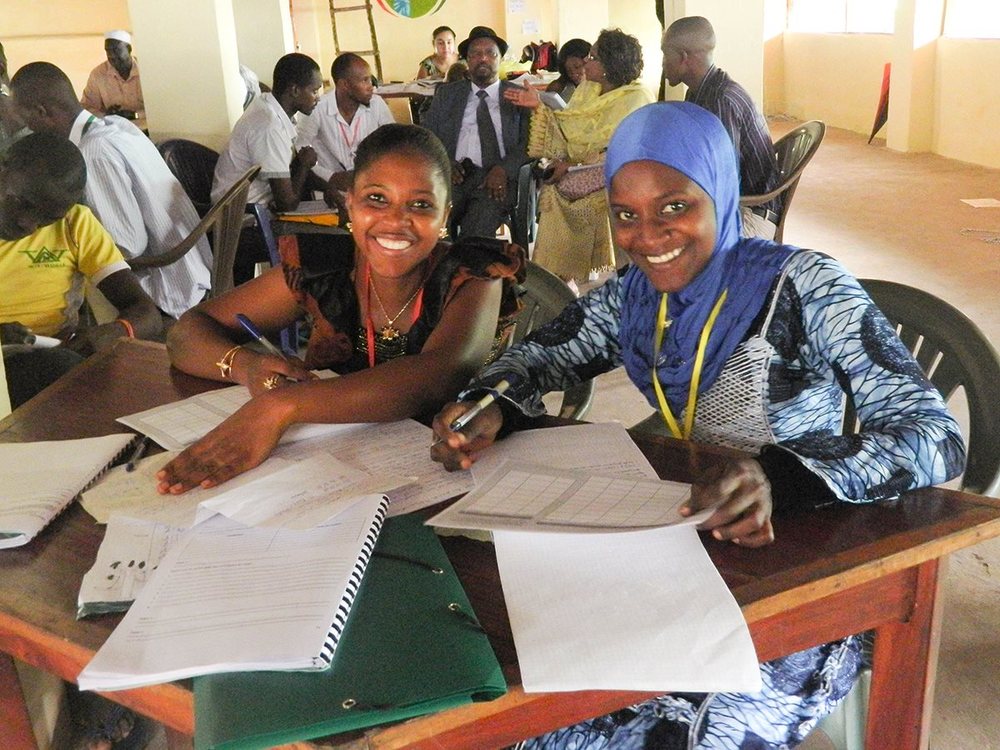 2 smiling students from partner in Guinea